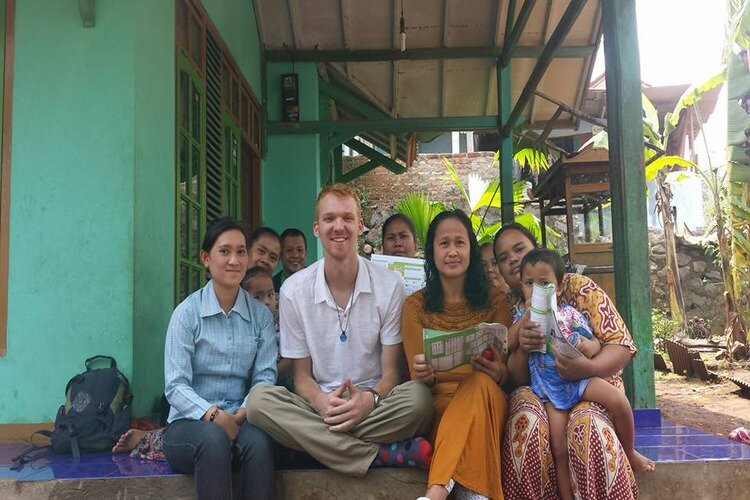 Dillon Barr, center, pictured with a group of people from one of his trips around the world.