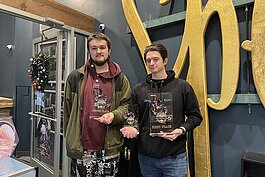 Owner Gage Badgerow (right) and Jerry Dickenson pose for a photo after a Yu-Gi-Oh! tournament at Dragon’s Den TCG in Port Huron.