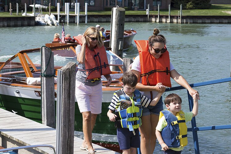 Boat show attendees make their way back to the River Street Marina boardwalk after receiving a free boat ride on Saturday, Sept. 11.