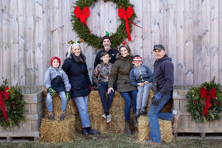 The Eifert family pose for a photo at Centennial Pines Tree Farm after cutting down their Christmas tree.