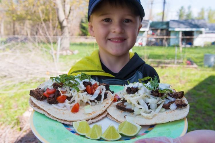 Eli shows off some of his daddy's food creations.