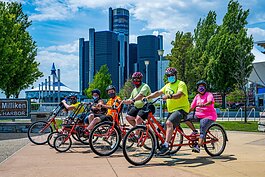 PEAC students Conor Waterman, Amanda Salinas, Owen Conley, Shawn Kohsmann, PEAC founder John Waterman, and PEAC student Tiara Sims on MoGo adaptive cycles on the Detroit Riverfront.