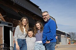 Nicole and Rob Fowler, the owners of Fowler's Creamery & Coffee, stand outside their storefront in downtown St. Clair with their children Nash (left) and Harper.