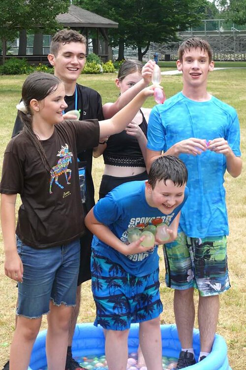 Participants in the Blue Water Homeschool Teens Cooperative enjoy a water balloon fight this summer at Pine Grove Park in Port Huron.