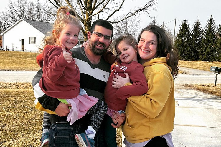 Alonna Hunt poses for a photo with her husband, Branden, and daughters Eve (left) and Lilly. 