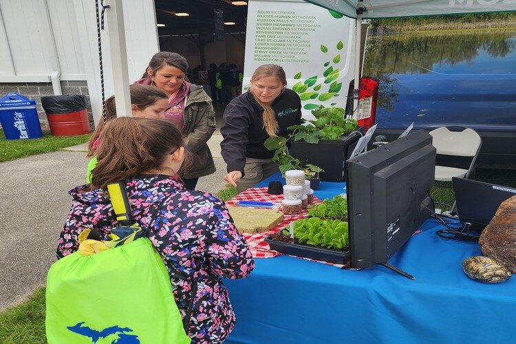 Visitors learning about Hydroponics from Huron-Clinton Metroparks at previous years Earth Fair.