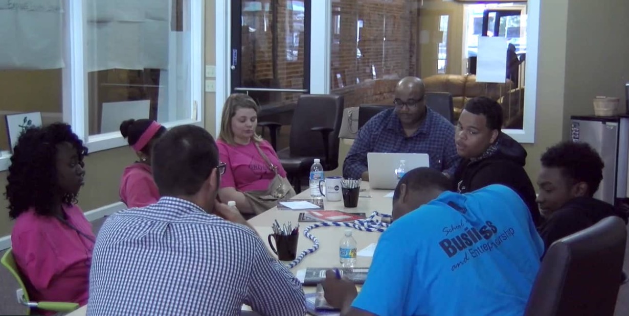 Quinten Bishop (with back to camera), Da'Rion Woods, Jalen Spear Nick Stewart, Kevin M. Totty, Sr., Breanna Griffin Crystyle and Williams Saniya Anderson talk at a meeting for The Crossing.