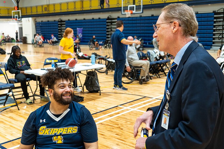 Jordan Scheidecker, Disability Resources Specialist at St. Clair County Community College (SC4) and Head Coach of the college’s wheelchair basketball team, chats with SC4 President, Kirk Kramer.
