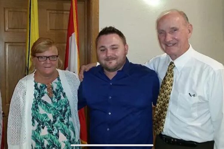 Brett Kodet (middle) with his parents Diane and Al.