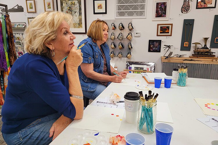 Local artists Tara Hutton (left) and SK Mabry participate in Mary's Color Theory III Class held at New Century Art Gallery in Marine City.
