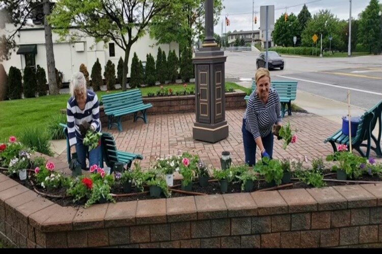 Leona Sebastian (left) and Paulette Butland, members of the St. Clair Garden Club working to beautify the city.