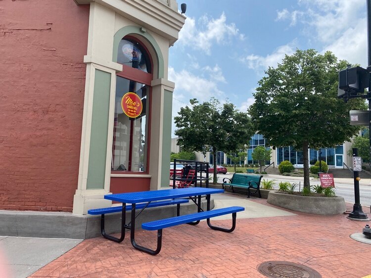 Moe's Corner Deli with one of the picnic tables on loan from Parks & Rec