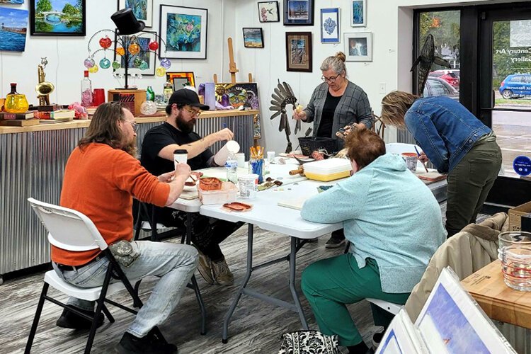 Veterans come together to enjoy a free class at New Century Art Gallery in Marine City.