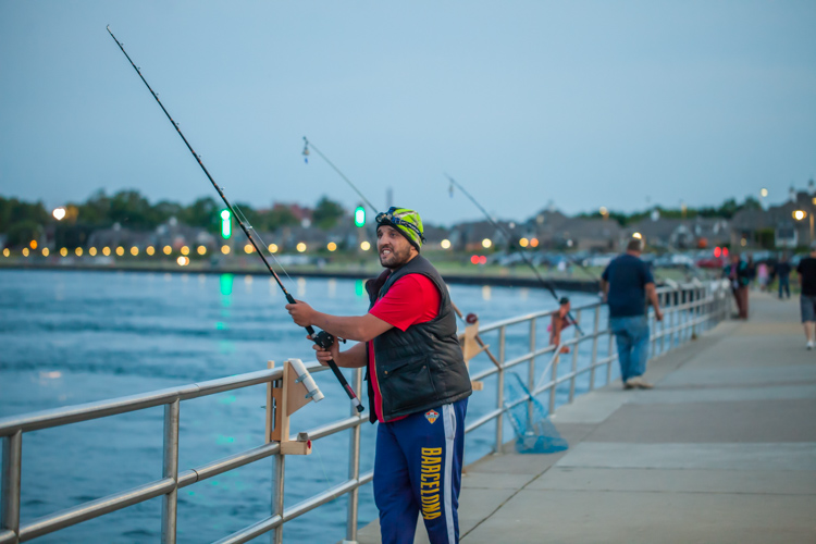 A group prepares to fish along the river.