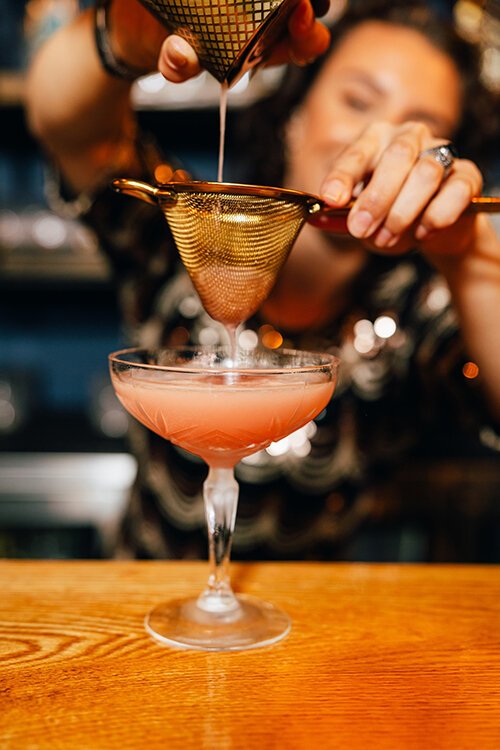 A bartender at Renaissance Man Distillery & Cocktail Lounge makes a Guava Daiquiri.