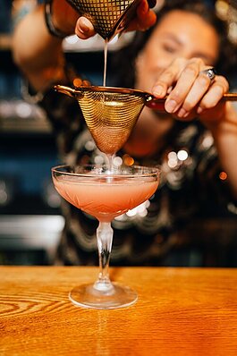 A bartender at Renaissance Man Distillery & Cocktail Lounge makes a Guava Daiquiri.