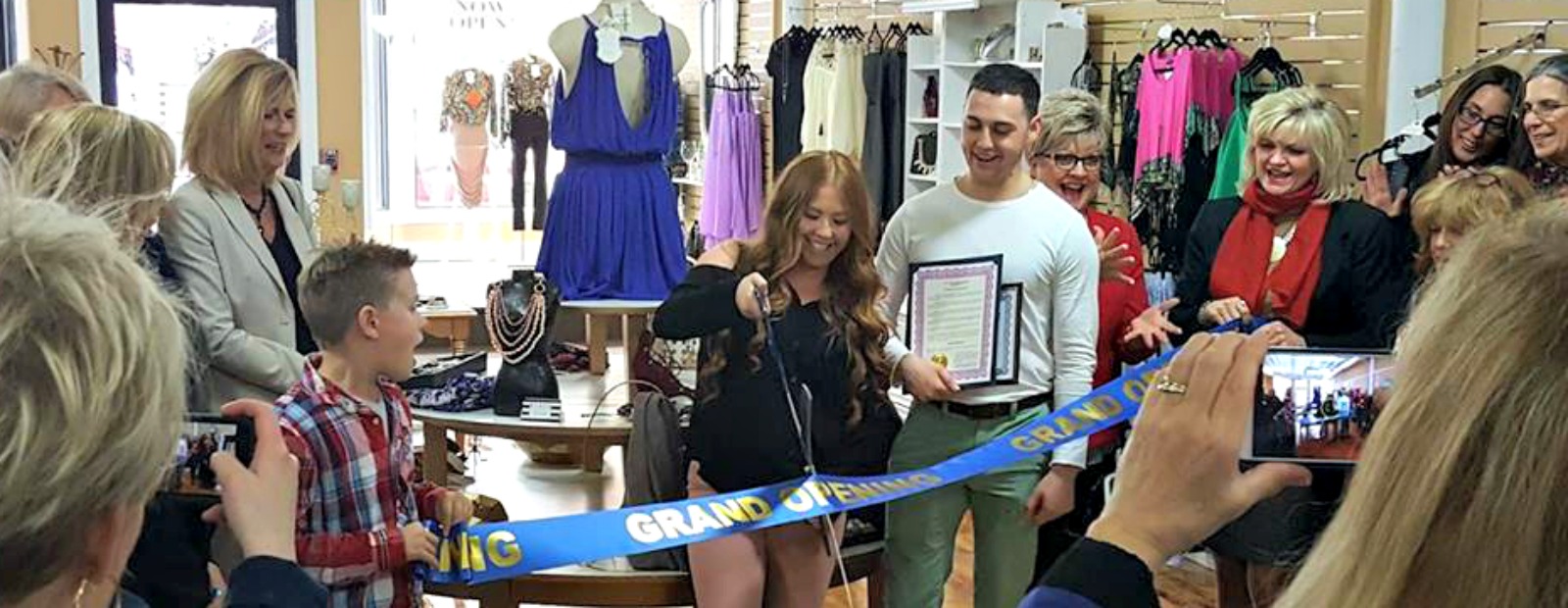 Demiree Potter cuts the ceremonial ribbon at her grand opening celebration.