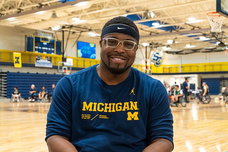 Dr. Oluwaferanmi Okanlami, Director of Student Accessibility and Accommodation Services at the University of Michigan, poses for a photo during the 3rd annual Wolverine Invitational.