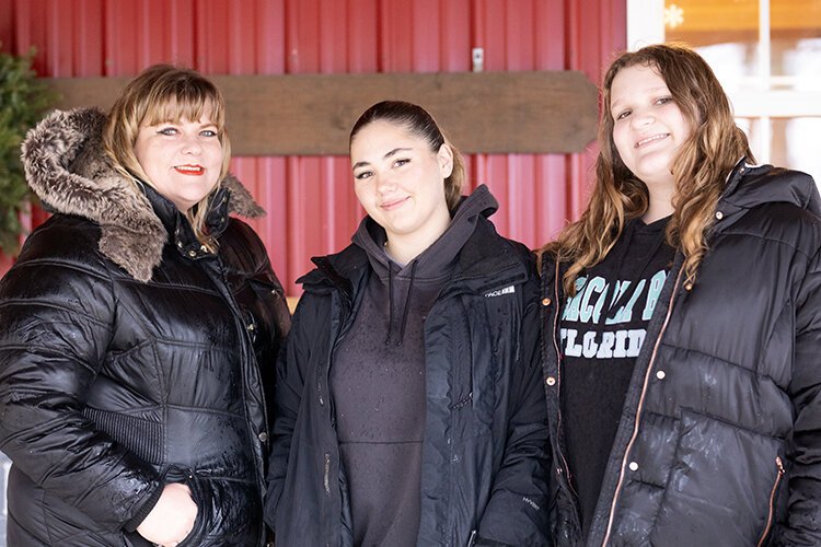 Alissa Lamorand (left), her daughter Lorelai (right), and foreign exchange student Isolda Bosch pose for a photo together after getting their Christmas tree from Shea Tree Farm.