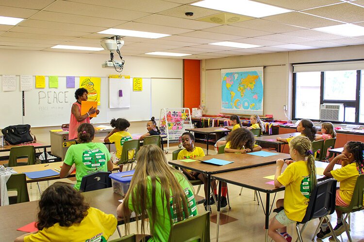 Arts & crafts teacher Ms. Shirley Lee — affectionately known as “Ms. Muppet” — works with students at Dream Camp.