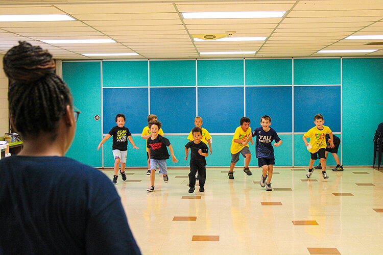 Dream Camp volunteer Mia Sutherland with class during a free play session at the Harrison Center.