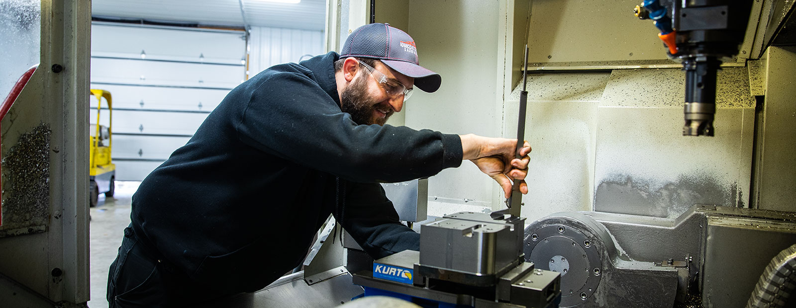 Employees check equipment at Advanced Automotive Group.