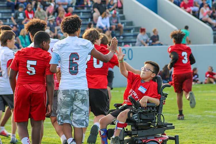 Port Huron High School players celebrate a touchdown with teammates during Victory Day.