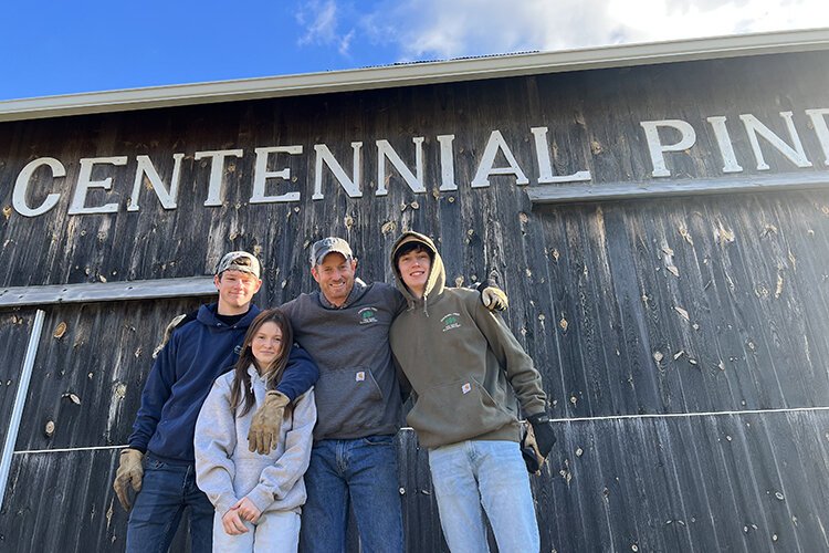 Mike Wendling (middle) poses for a photo with his sons Sean (left), Matt (right), and daughter Riley.