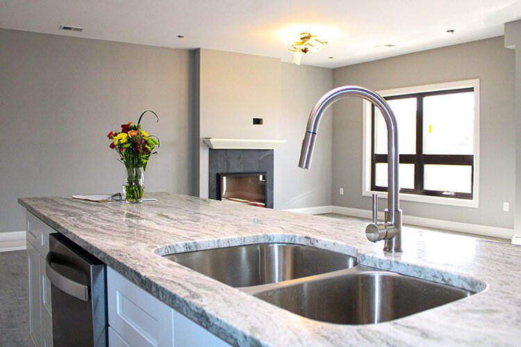 The kitchens at the Wrigley Center's lofts feature granite countertops, stainless steel appliances, and look out onto an open floor plan.