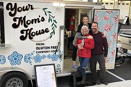 Owner Amy Schmidt (back) poses for a photo with Nicole Jaqueline Pauly and Bill Schmidt.