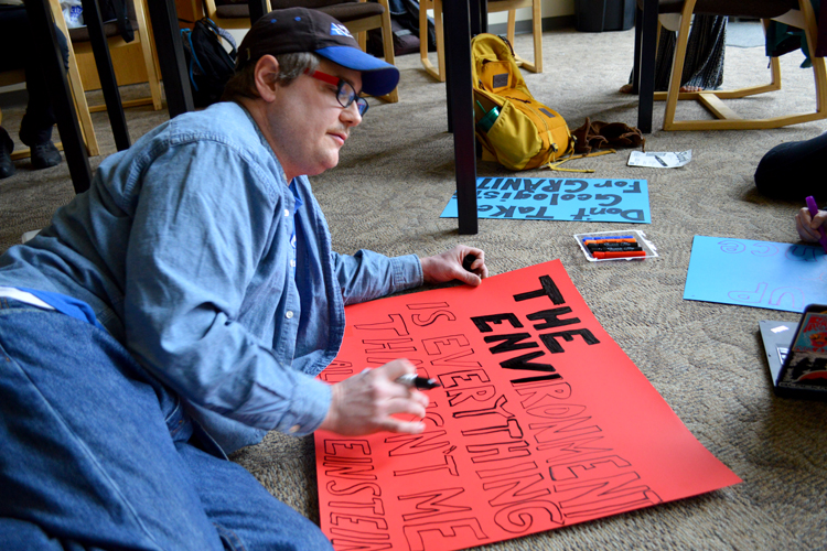 In the central U.P., Jeff Jonas works on an Einstein-inspired sign.