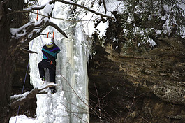 A participant in the IceFest women's ice-climbing clinic takes on Twin Falls near Munising.