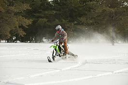 Cody Huebner demonstrates a modified dirt bike for use on snow.