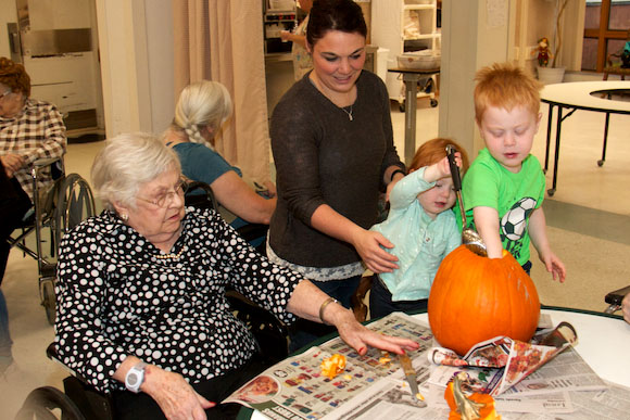 Pumpkin carving at Eastwood Nursing Home in Negaunee connects youth in need of social support to more than one generation.