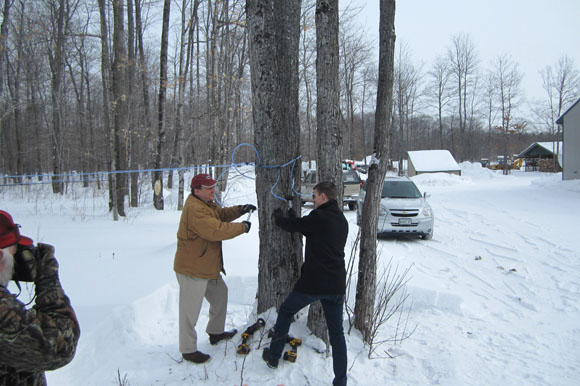 A ceremonial first tapping in Rudyard last year with State Senator Wayne Schmidt and State Representative Lee Chatfield.