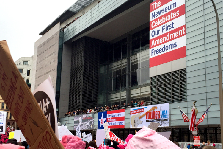 The march passes the Newseum in D.C. 