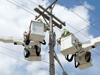 Alger Delta Cooperative linesmen work on a transformer.