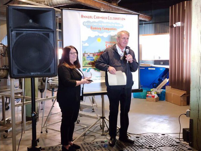 Bill Ramsey accepts the Alger Chamber of Commerce Business Recognition Award from Julie Bosanic of Michigan Works!