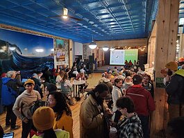 Over 300 Michigan Ice Fest participants flock into Gallery Coffee Company in downtown Munising on Friday, Feb. 9, for a presentation on sustainable ice climbing practices.