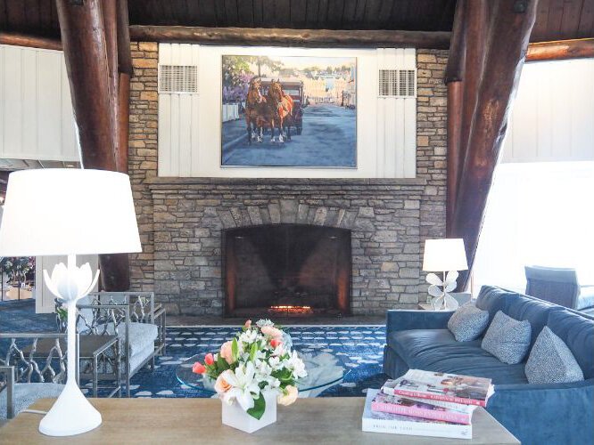 The redesigned lobby is open and light. The painting above the fireplace is by Michigan artist Kristin Hosbein.