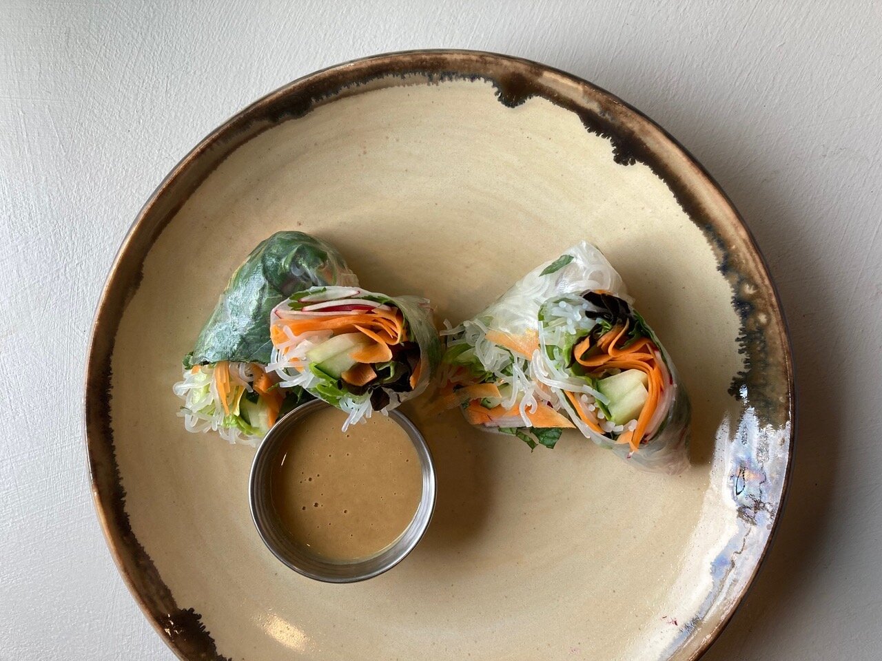 Gluten-free salad rolls are stuffed with local carrots, greens and radishes.