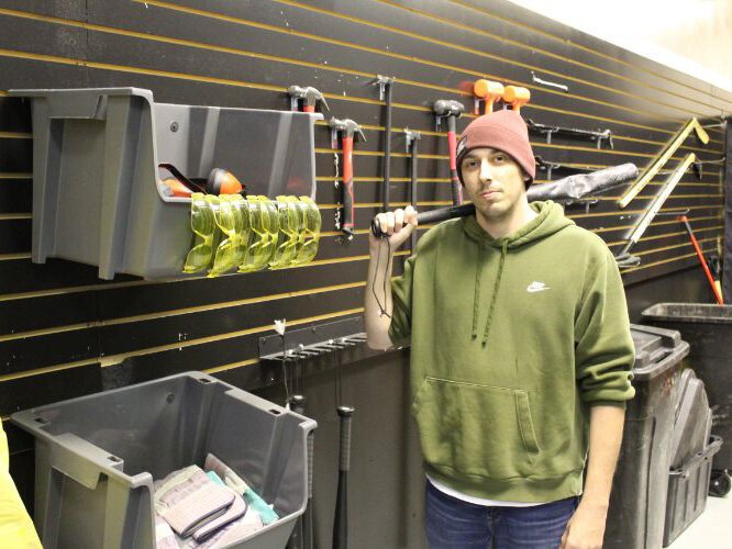 Co-Owner Myles Moncalieri stands in front of various devices used to break stuff in Marquette’s newest attraction The Rampage Room.
